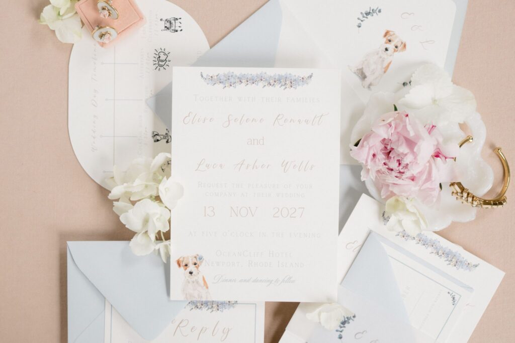 Wedding invitation suite with envelope liner, soft blue envelope, and subtle dog illustration detail